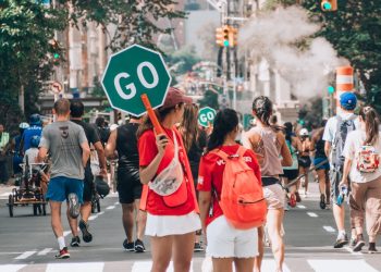 woman in red top holding Go sign