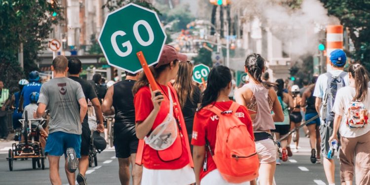 woman in red top holding Go sign