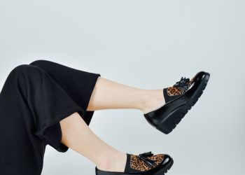 woman in black pants wearing black leather peep toe heeled shoes