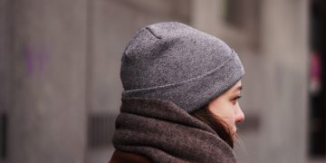 person in gray knit cap and brown hoodie
