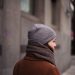 person in gray knit cap and brown hoodie