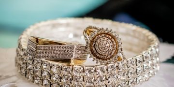 a close up of two rings on a white cloth