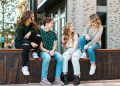 a group of young women sitting on a bench
