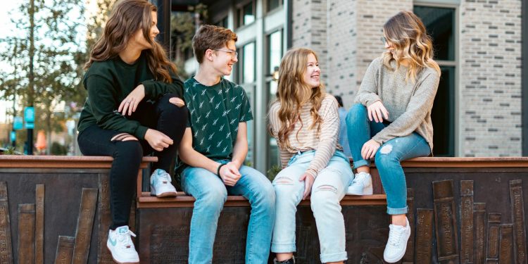 a group of young women sitting on a bench