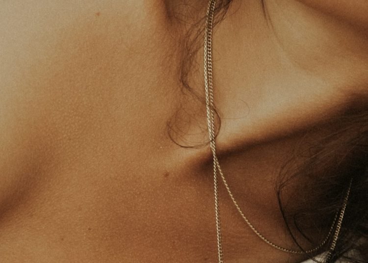 woman in white tank top wearing silver necklace