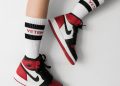 person wearing pair of black toe Air Jordan 1's