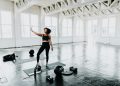 a woman is doing exercises in a gym