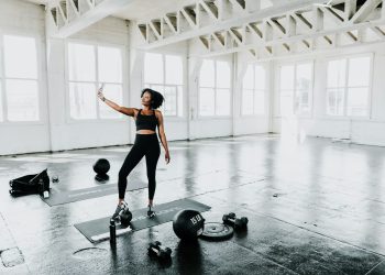 a woman is doing exercises in a gym