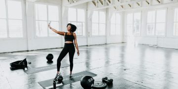 a woman is doing exercises in a gym