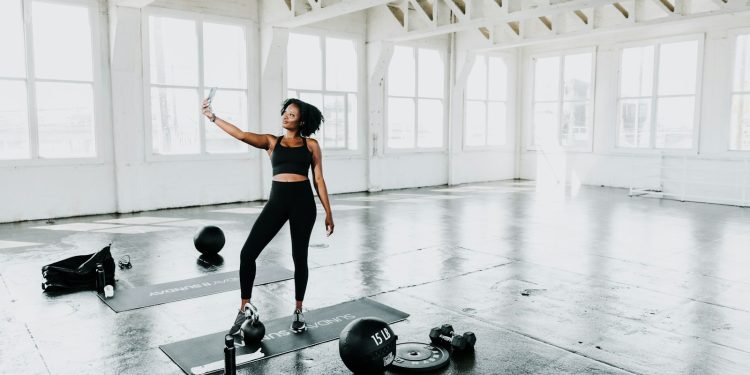 a woman is doing exercises in a gym