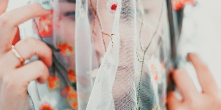 woman in white red and green floral dress
