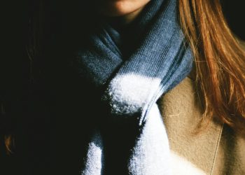 woman wearing brown top and black scarf