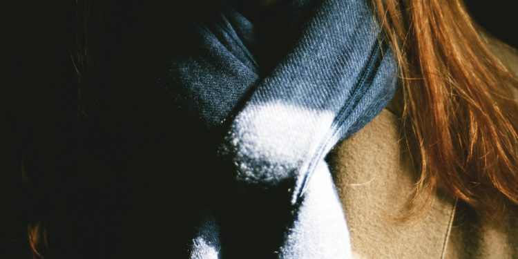 woman wearing brown top and black scarf