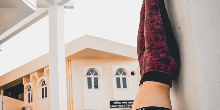 person in black and white nike running shoes and red pants