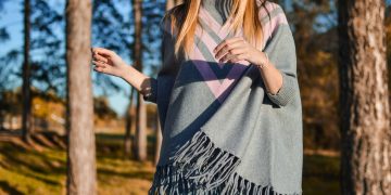 woman standing surrounded by tress