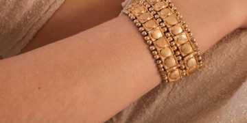 a person wearing a gold bracelet
