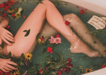 bathtub with water and flowers