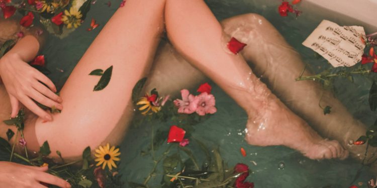 bathtub with water and flowers
