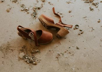 pair of brown ankle-strap sandals on floor