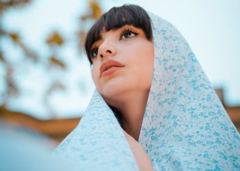 woman in blue scarf and teal shirt