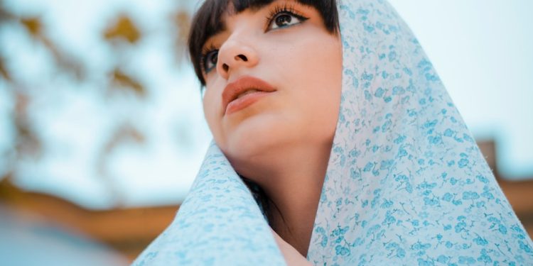 woman in blue scarf and teal shirt