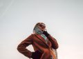 woman wearing brown peaked-lapel topcoat