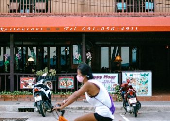 man in white shirt riding on bicycle during daytime