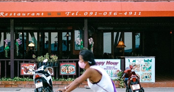 man in white shirt riding on bicycle during daytime