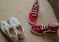 a pair of red and white tennis shoes on the floor